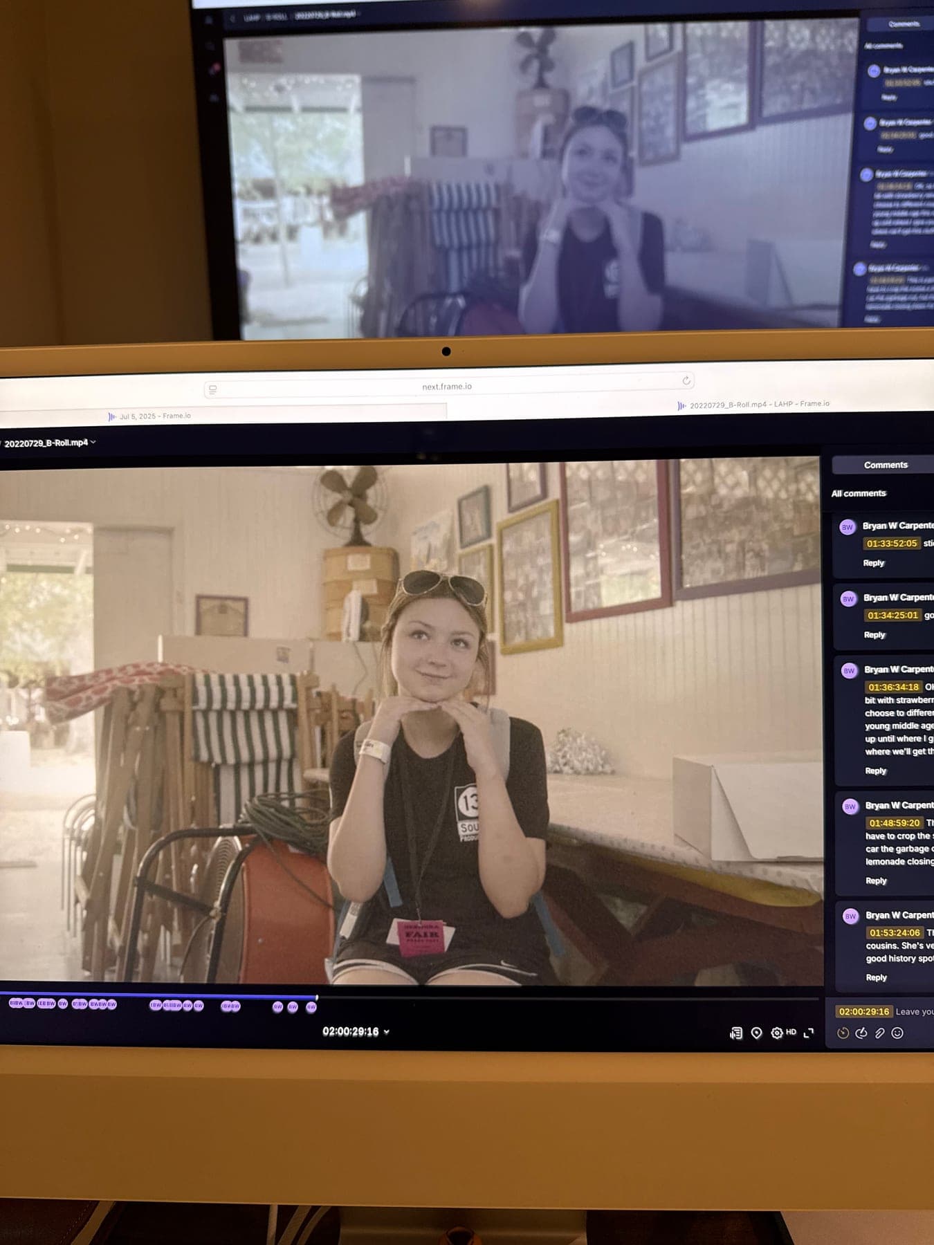 An edit bay with two screens showing footage